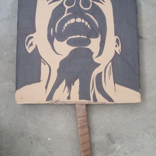 Placard with an image of a black man screaming 
