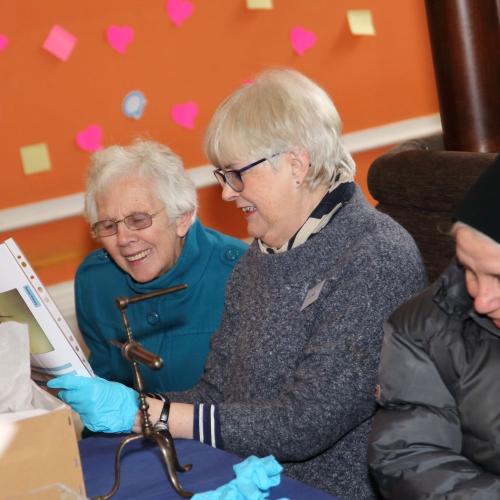 Photograph of a group looking at an object