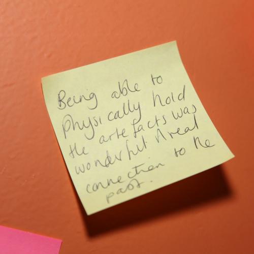 Post it note feedback saying "Being able to physically hold the artefacts was wonderful. A real connection to the past"