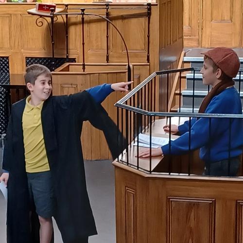 Children playing clerk and defendant in courtroom