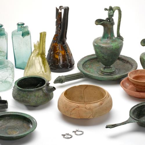 A Collection Of Glass, Pottery and Metal Items Found In A Burial Site Called Turners Hall Farm