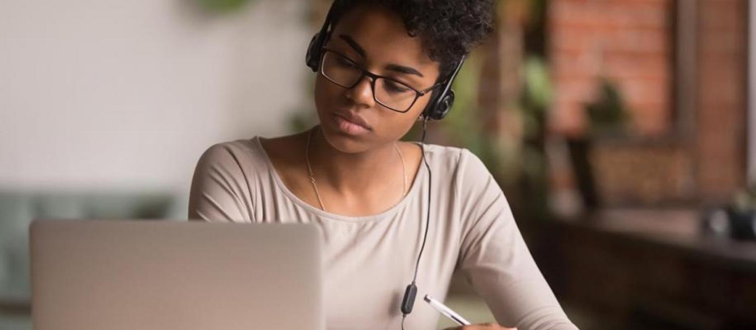 woman listening to a call on a laptop