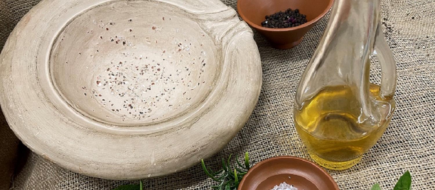 Roman food preparation with mortatium, olive oil, herbs, salt and peppercorns