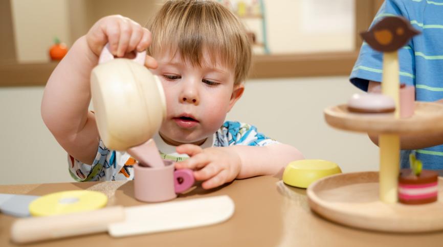 Child with toy teapot