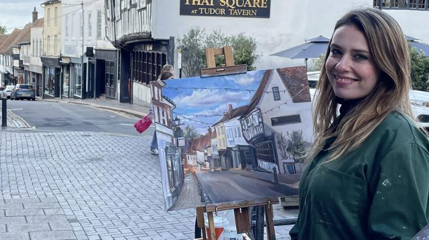 Colour photograph of Donna Borg painting at the top of Groerge Street St Albans