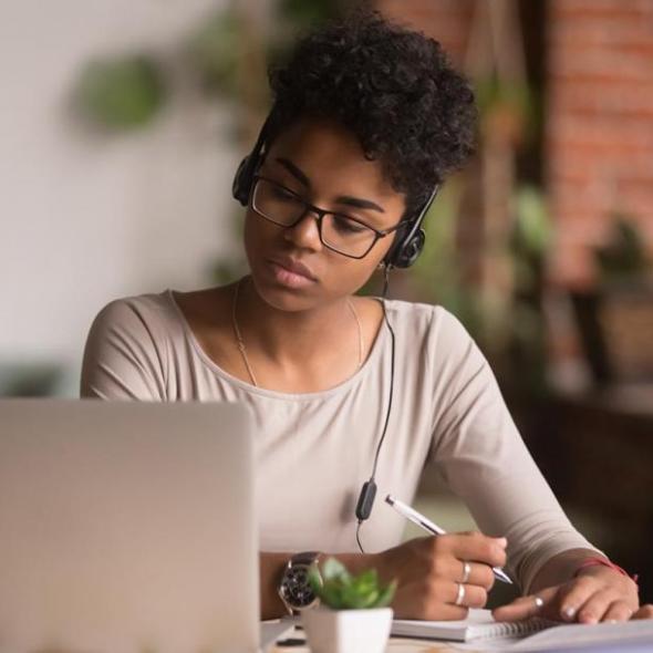 woman listening to a call on a laptop