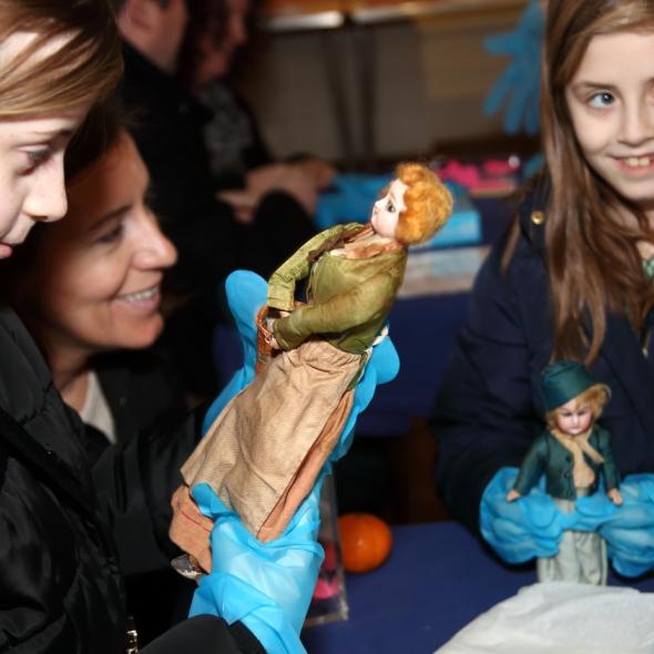 Children looking at dolls