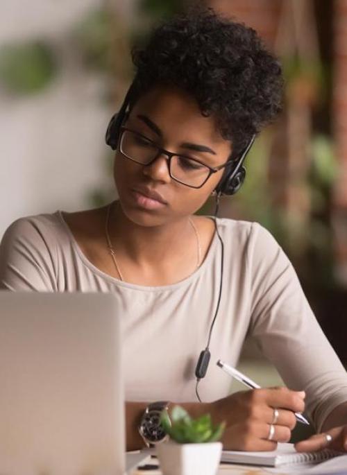 woman listening to a call on a laptop